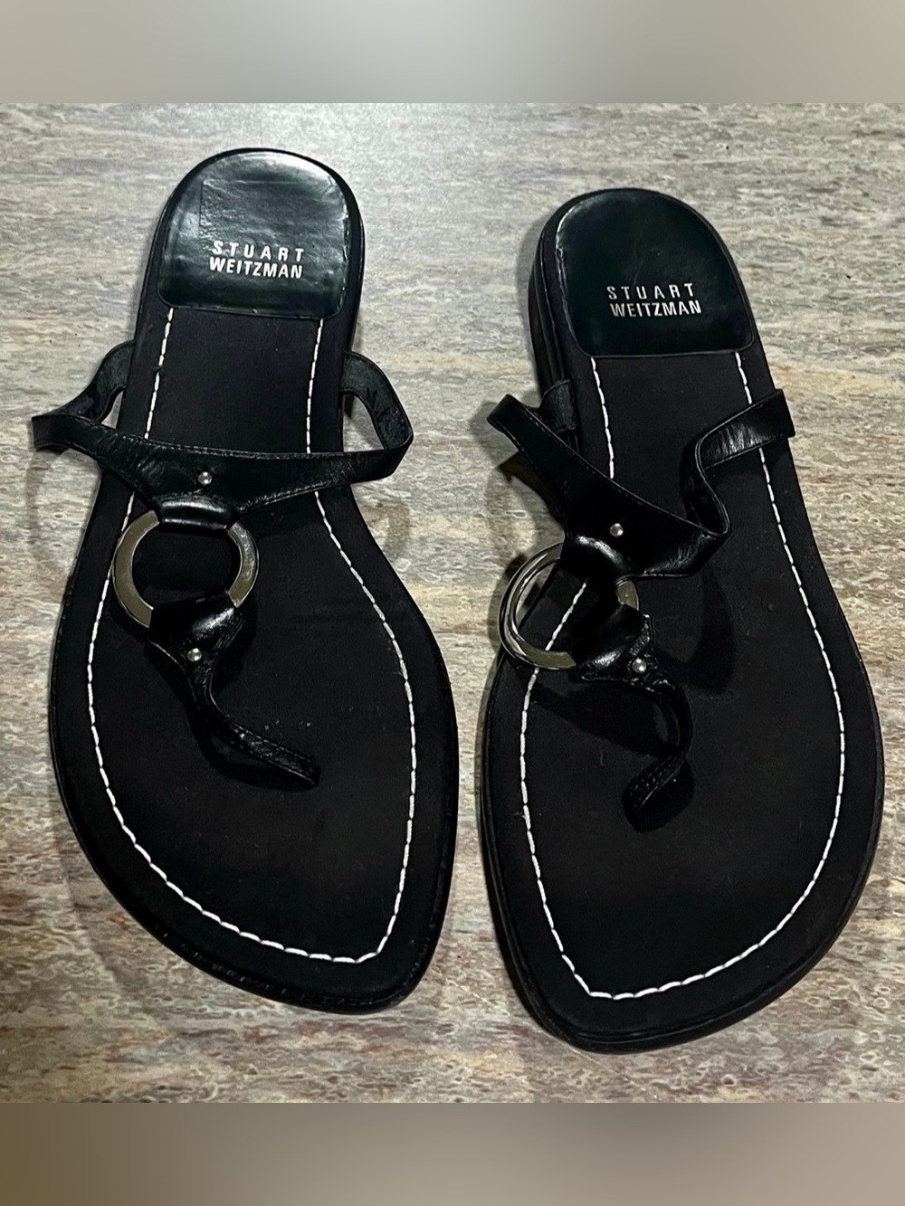 Stuart Weitzman Women’s Black Leather Thong Sandals with Silver Ring-Accent